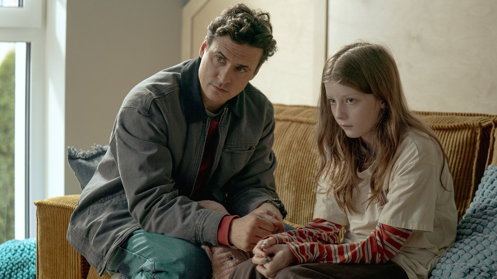 The Mothers of Penguins 2. sezon 21 Ekim’de Netflix’te: Ebeveynler bu kez kendi okullarını kuruyor 2026 – 1 The Mothers of Penguins 2. sezon resmi karesinden bir evin salonunda kanepede oturup küçük bir kızla konuşan genç bir adam