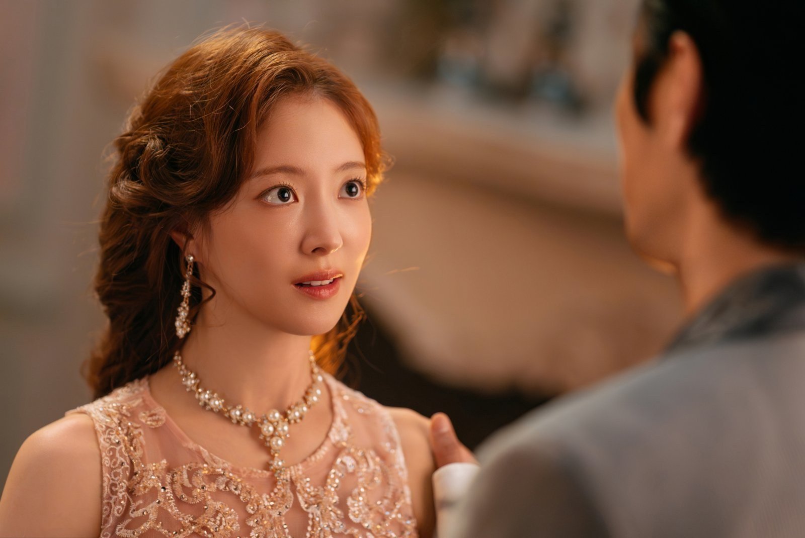 The Remarried Empress resmi karesinde pembe elbise ve inci kolyeyle karşısındaki adama bakan Rashta rolündeki Lee Se Young